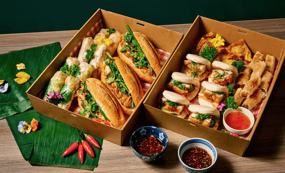 Boxes of assorted Vietnamese bánh mì and share plates at ĂN ĐI near Marvel Stadium
